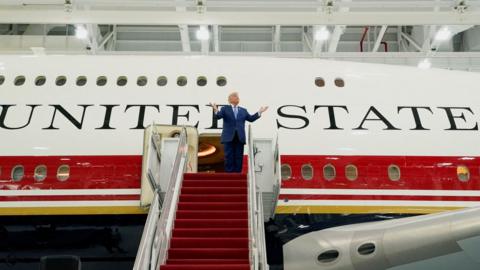 U.S. President Donald Trump gestures as he tours the VC-25B aircraft gifted by Qatar that will be used as Air Force One