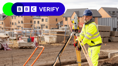 Surveyor builder site engineer at construction site outdoors during surveying work