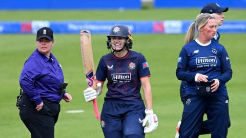Gaby Lewis raises her bat on reaching 50 v Hampshire