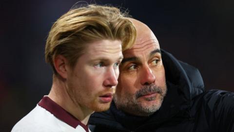 Manchester City manager Pep Guardiola gives instruction to Kevin de Bruyne