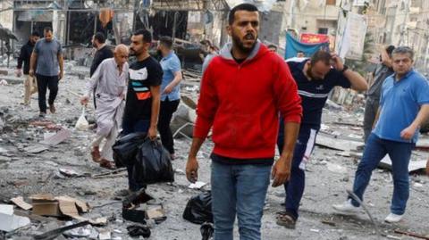 Palestinians at scene of air strike in northern Gaza Strip (13/10/23)