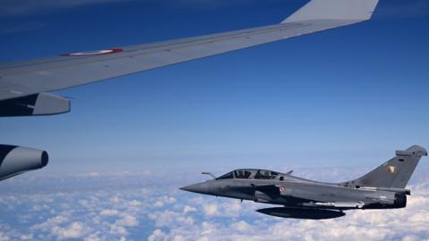 Rafale fighter flies by a new Airbus A330 near Paris on 21 September 2021