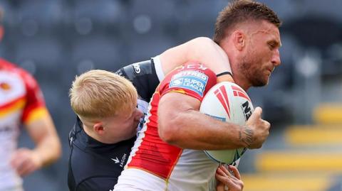 Hull FC's Matty Laidlaw (left) tackling Catalans Dragons' Tariq Sims in a match last season. 