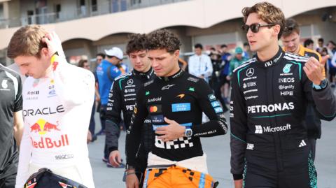 Red Bull's Max Verstappen, McLaren's Lando Norris and Mercedes' George Russell pictured together, with Mercedes' Kimi Antonelli in the background, during pre-season testing in Bahrain