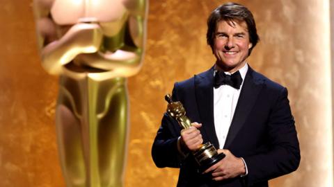 Tom Cruise wears a tuxedo and poses with his honorary Oscar during the Academy of Motion Picture Arts and Sciences 16th Governors Awards in Los Angeles on 16 November.