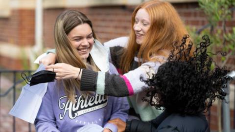 Emelia Ambrose embraces her friend Mali Jones after opening her A Level results at Ffynone House school