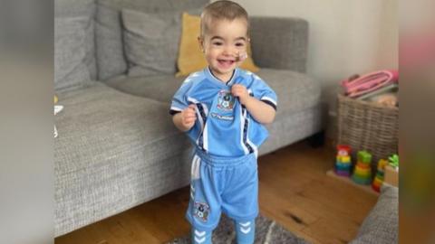 Hallie wearing Coventry City children's kit