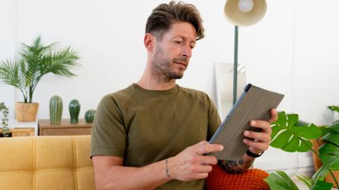 Man reading on tablet