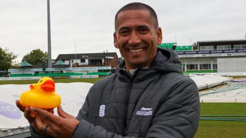 Alfonso Thomas holding a rubber duck