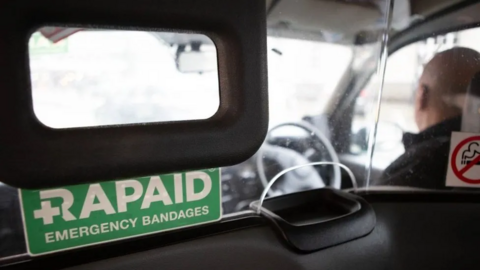 A green Rapaid sticker in a taxi