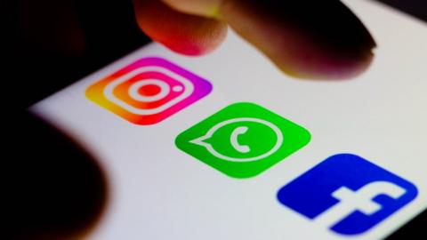 Instagram, Whatsapp and Facebook logos on a smartphone