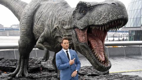 Actor Chris Pratt and a model T-Rex