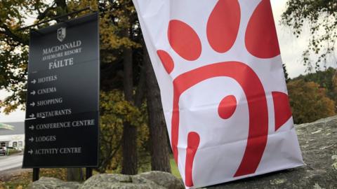 Chick-fil-A bag and MacDonald Aviemore resort sign