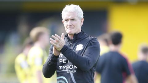 Mark Hughes claps Carlisle fans after a pre-season friendly