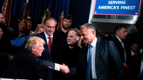 US President Donald Trump shakes Ike Perlmutter, CEO of Marvel Entertainment, hand before signing an executive order at the US Department of Veterans Affairs April 27, 2017 in Washington, DC.