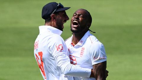 England fast bowler Jofra Archer (right) roars in celebration after taking a wicket