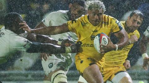Dragons wing Fine Inisi makes a break against Sharks in the rain at Rodney Parade