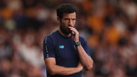 Brian Barry-Murphy watches a Cardiff City games, with one hand to his mouth and the other across his body