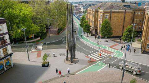 An artist impression of the plans. There is a green cycle path running in the distance of the image - through Gloucester city centre. There are two lanes to the cycle path.