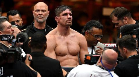 Rico Verhoeven is surrounded by people in the ring following his defeat by Oleksandr Usyk