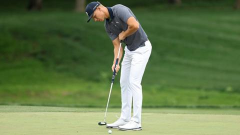 Matti Schmid lines up a putt with his broom-handle putter