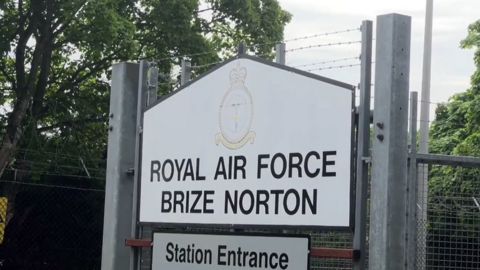 A close up of the sign of the entrance to RAF Brize Norton. 