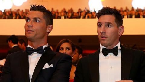 Lionel Messi and Cristiano Ronaldo sitting next to each other at an awards ceremony