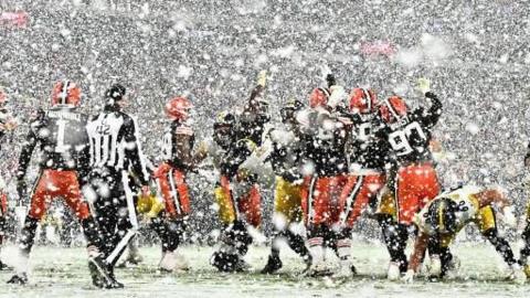 Cleveland Browns and Pittsburgh Steelers players in the snow