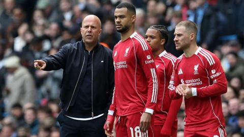 Arne Slot on the touchline talking to Cody Gakpo, Rio Ngumoha and Alexis Mac Allister