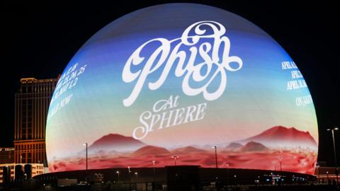 An advertisement for Phish concerts is displayed on the Sphere in Las Vegas