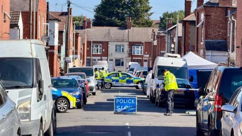 Police cordon in place with vehicles either side of the road