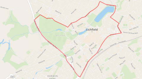 A map of Lichfield city centre, with a large area marked in red covering a significant number of streets, a park and two bodies of water