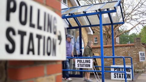 Two people leaving a polling station 