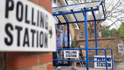 Two people leaving a polling station 
