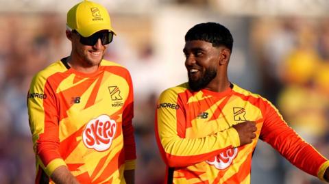Rehan Ahmed shares a joke with Joe Root