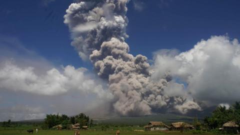 A giant mushroom-shaped cloud rises into the air from the Mayon volcano, seen from the highway in the town of Camalig, near Legazpi City in Albay province, south of Manila on 22 January 2018.