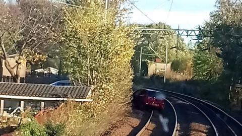 Car on the rail line between Bowling and Kilpatrick