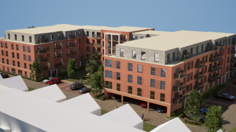 Computer generated image of a U-shaped development with four floor of brown building with a grey upper floor. Cars are parked underneath