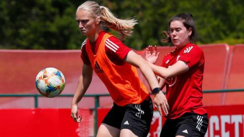 Elise Hughes shielding the ball in training from Esther Morgan