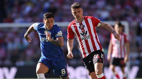Granit Xhaka of Sunderland takes the ball past Enzo Fernandez of Chelsea