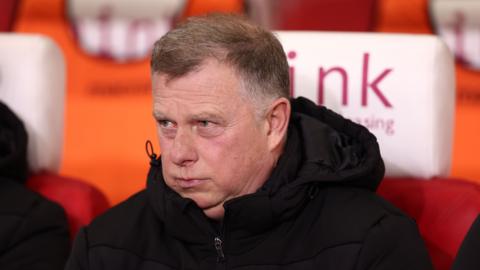 Stoke City boss Mark Robins head shot blowing out cheeks