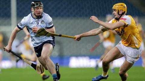 Antrim sweeper Niall O'Connor attempts to keep pace with Dublin's Cian O'Sullivan at Croke Park