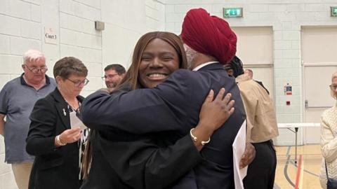 Two people hug at a count in Bexley