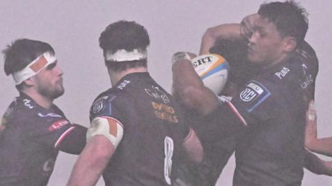 Sam Lousi of Scarlets wins the ball