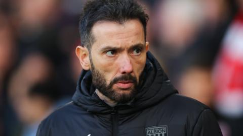 West Brom head coach Carlos Corberan watches on from the dugout during a game