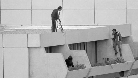 Munich: Armed police drop into position on a terrace directly above the apartments where between nine and 26 members of the Israeli Olympic team are being held hostage 9/5 by Arab "Black September" extremeists.