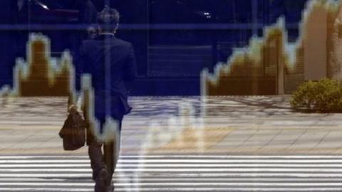 Man reflected in an electronic board