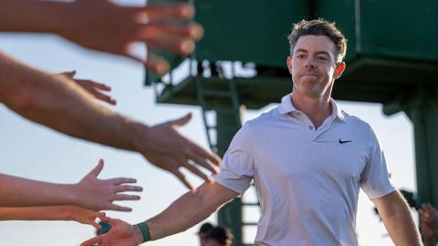 Rory McIlroy greets fans after his second-round 65