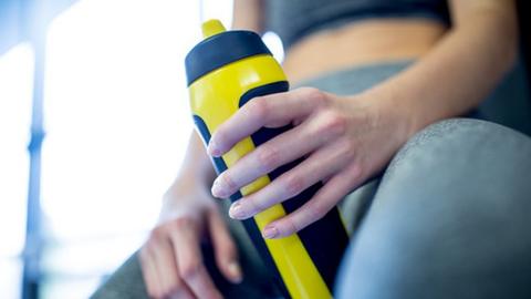 woman holding a water bottle