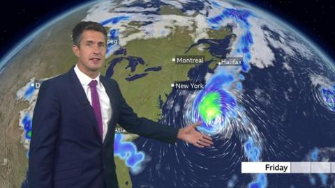 Chris Fawkes standing in front of a weather map of the US showing the path of Hurricane Lee